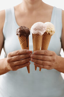 Woman holding different ice creams, upper section, close-up - SCF00351