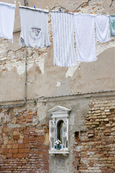 Italy, Venice, Old brick wall, Madonna image, clothesline - AWDF00198