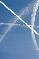 Condensation trails in sky, low angle view - AWDF00129