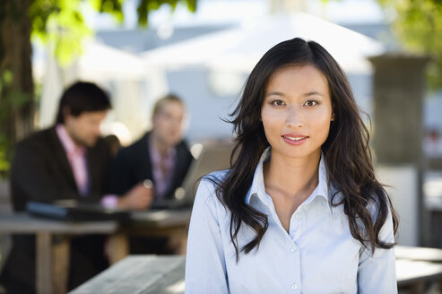 Germany, Bavaria, Upper Bavaria, Asian woman in beer garden, portrait - WESTF09768