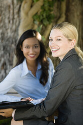 Germany, Bavaria, Upper Bavaria, Two Business women in beer garden - WESTF09762