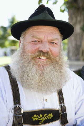 Germany, Bavaria, Upper Bavaria, Bavarian man wearing traditional costume, smiling, portrait, close-up stock photo