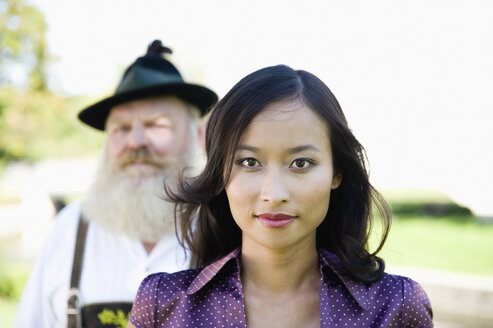 Germany, Bavaria, Upper Bavaria, Young Asian woman and old Bavarian man - WESTF09676