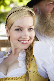 Germany, Bavaria, Upper Bavaria, Young woman in traditional costume, smiling, portrait, close-up - WESTF09652