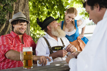 Germany, Bavaria, Upper Bavaria, People in beer garden playing cards - WESTF09647