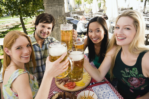 Germany, Bavaria, Upper Bavaria, Young people in beer garden, smiling - WESTF09600