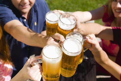 Germany, Bavaria, Upper Bavaria, Cheerful people toasting each other in beer garden, elevated view - WESTF09592