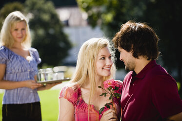 Germany, Bavaria, Upper Bavaria, Young couple in beer garden, portrait - WESTF09575