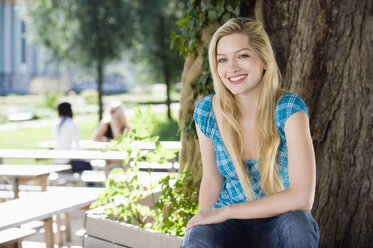 Germany, Bavaria, Upper Bavaria, Young woman in beer garden, smiling, portrait - WESTF09555