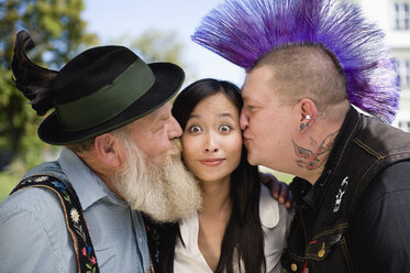 Germany, Bavaria, Upper Bavaria, Two men kissing Asian woman on cheek, portrait - WESTF09550