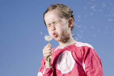 Young girl (6-7) blowing a dandelion - CLF00592
