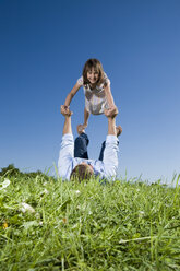 Father and daughter (6-7) playing in the meadow - CLF00569