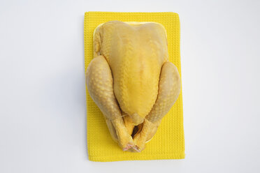 Raw chicken on dish towel, elevated view - GWF00861