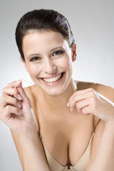 Young woman flossing her teeth, close up - MAEF01295