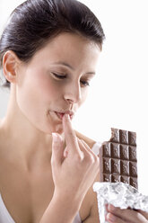 Young woman holding chocolate bar, - MAEF01266