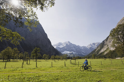 Austria, Karwendel, Senior woman biking - WESTF10525