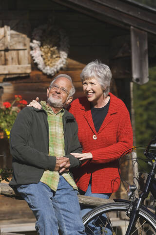 Austria, Karwendel, Senior couple in front of log cabin stock photo