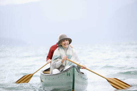 Germany, Bavaria, Walchensee, Senior couple rowing boat on lake stock photo