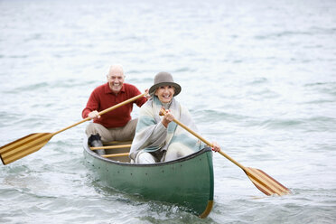 Germany, Bavaria, Walchensee, Senior couple rowing boat on lake - WESTF10213