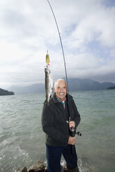 Germany, Bavaria, Walchensee, Senior man fishing in lake - WESTF10207