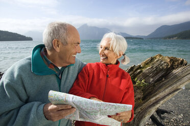 Germany, Bavaria, Walchensee, Senior couple looking at map - WESTF10193