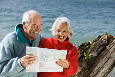 Germany, Bavaria, Walchensee, Senior couple looking at map - WESTF10192