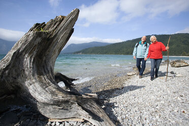 Germany, Bavaria, Walchensee, Senior couple hiking on lakeshore - WESTF10185