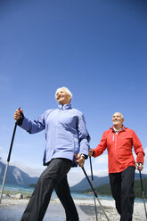 Germany, Bavaria, Walchensee, Senior couple, Nordic Walking on lakeshore - WESTF10177