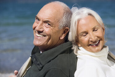 Germany, Bavaria, Senior couple relaxing on lakeshore, back to back, close up, portrait - WESTF10145