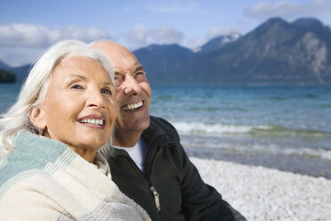 Germany, Bavaria, Walchensee, Senior couple relaxing on lakeshore - WESTF10138