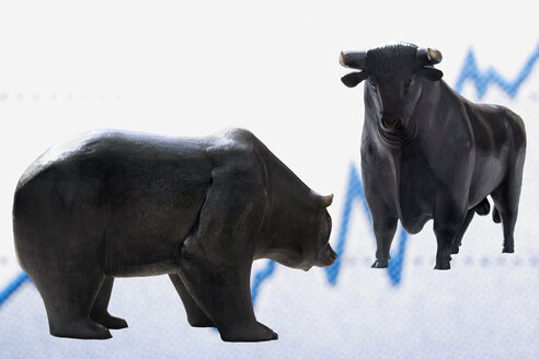 Bull and bear figurines in front of graph, close-up - TCF01133