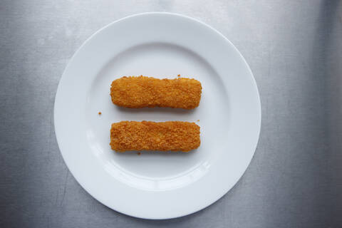 Fish fingers on plate, elevated view stock photo