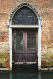 Italy, Venice, Old building with door on the waterfront - WWF00342