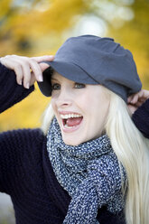 Young woman with cap and scarf, laughing, portrait - MAEF01470