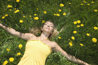 Austria, Salzburger Land, Young woman relaxing in meadow, eyes closed - HHF02793