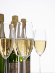 Champagne bottles and Champagne Glasses in foreground, close-up - AKF00068