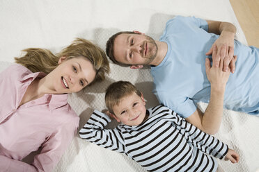 Parents and son relaxing at home, elevated view - CLF00666
