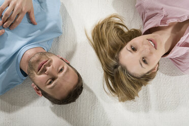 Young couple relaxing on carpet, elevated view - CLF00665