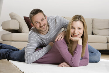 Young couple relaxing on carpet - CLF00643