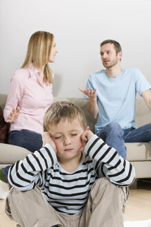 Parents arguing, boy (4-5) sitting in foreground - CLF00637