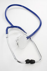 Stethoscope on white background, elevated view - JRF00098