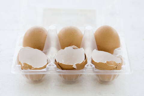 Eggs and Egg shells in egg box stock photo