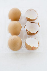 Eggs and Egg shells in egg box, elevated view - JRF00084