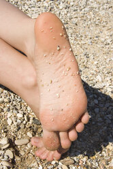 Greece, Ithaca, Bare feet in sand, close-up - MUF00774