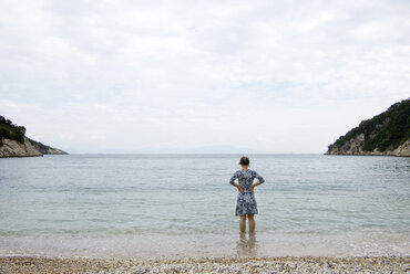Greece, Ithaca, Woman wading in ocean, rear view - MUF00765