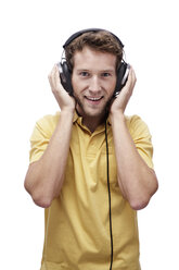 Young man wearing headphones, portrait - BMF00521