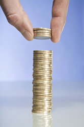 Person stacking Euro coins, close up - CLF00691