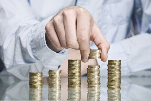 Person stacking Euro coins, close up - CLF00689