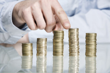 Person stacking Euro coins, close up - CLF00688