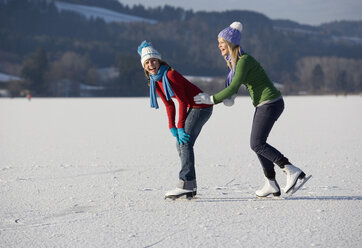 Austria, Salzkammergut, Lake Irrsee, Female teenagers (14-15) skating, having fun - WWF00832